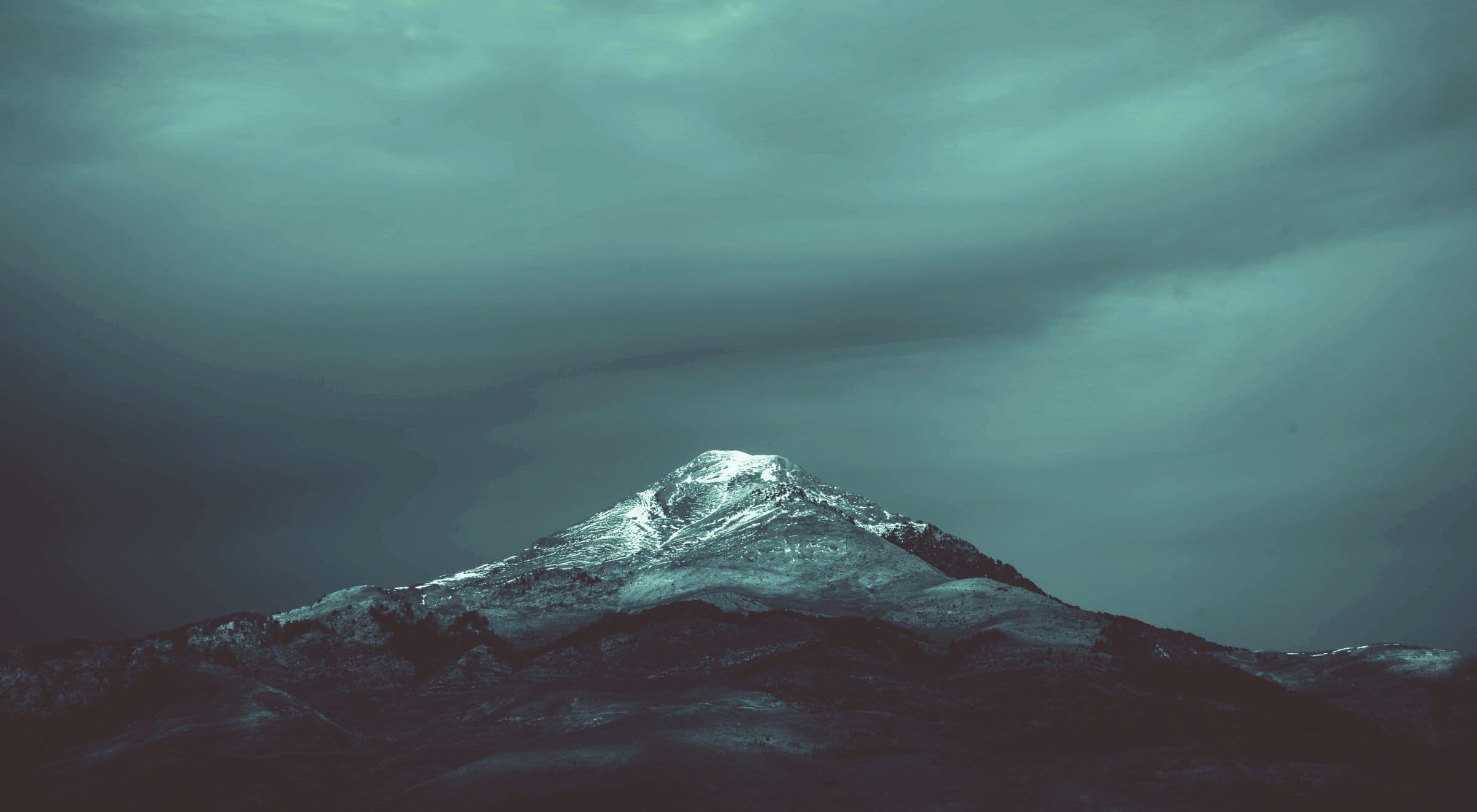 Mist settling over layered mountain ridgelines at dawn